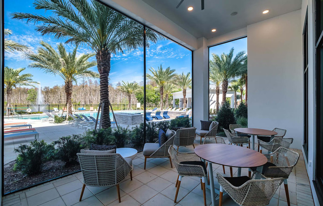 a patio with tables and chairs next to a swimming pool at Altis Grand Suncoast, Florida, 34638
