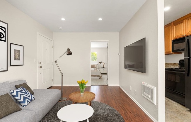 Apartments for Rent in West Hills, CA - Topanga - Living Room with Wood-Style Flooring, TV, and Couch.