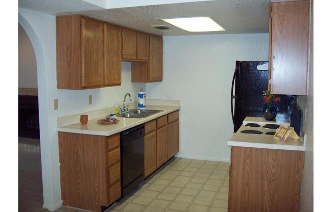 a kitchen with a stove sink and refrigerator