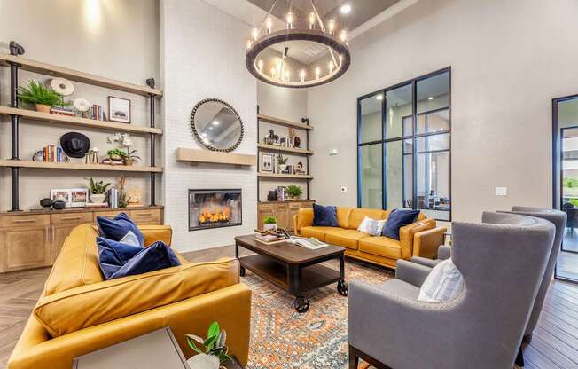 A living room with a yellow couch, a grey armchair, and a coffee table.