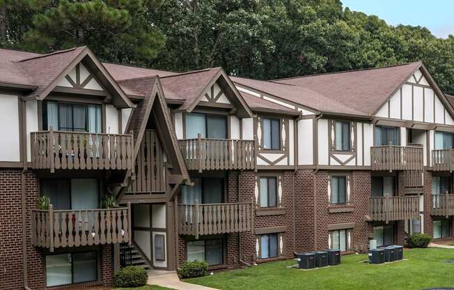 Apartment building with brown brick and white walls.