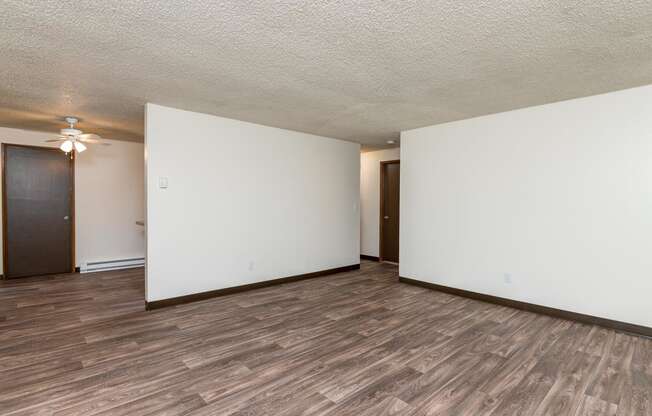 Pinewood Terrace Apartments | Living Room open to dining room and hallway.