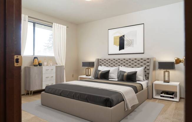 Large bedroom with natural light from window staged with bed, side tables, and wall art. at Hawks Prairie, Olympia