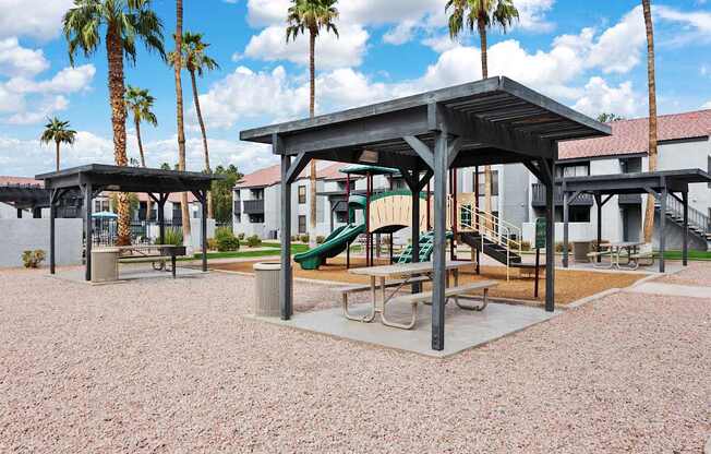A playground with a slide and a pavilion.