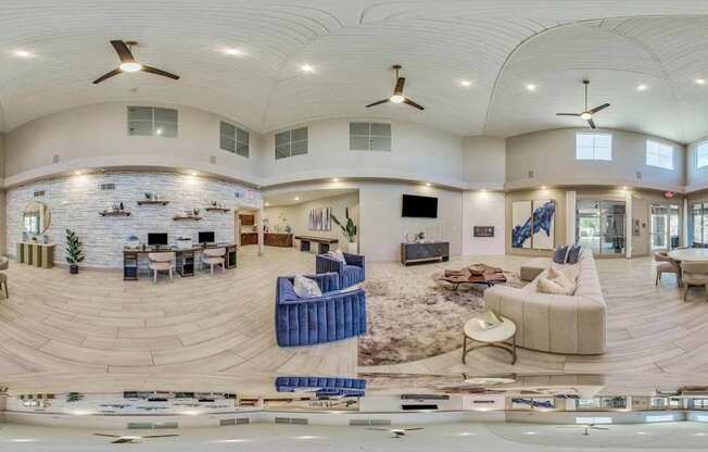 A spacious living room with a curved ceiling and a stone fireplace.