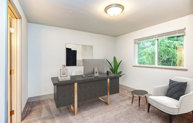 an office with a desk and a chair and a window