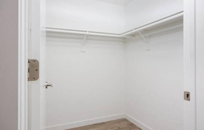 an empty room with white walls and a white door