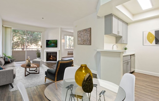 a living room with a glass table and chairs at Palm Royale Apartments, California, 90034