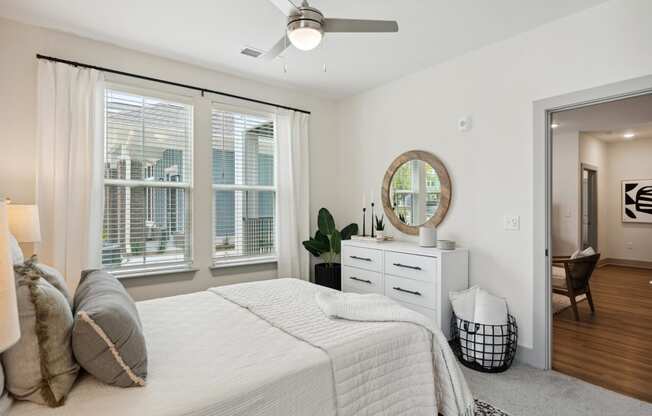 a bedroom with a bed and a large window