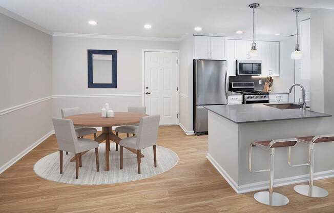 a kitchen and dining room with a table and chairs