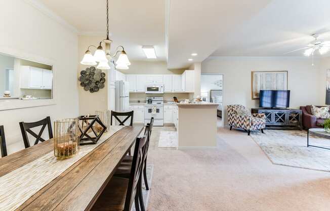 a living room with a dining room table and a kitchen