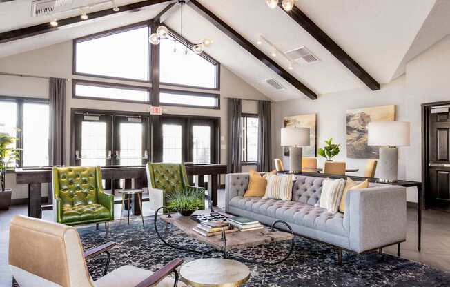 a living room with couches and chairs and a rug