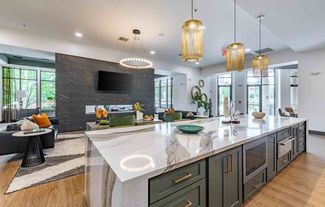 a large kitchen with an island and a living room with a tv