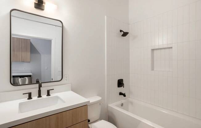 a bathroom with a sink and a tub and a mirror