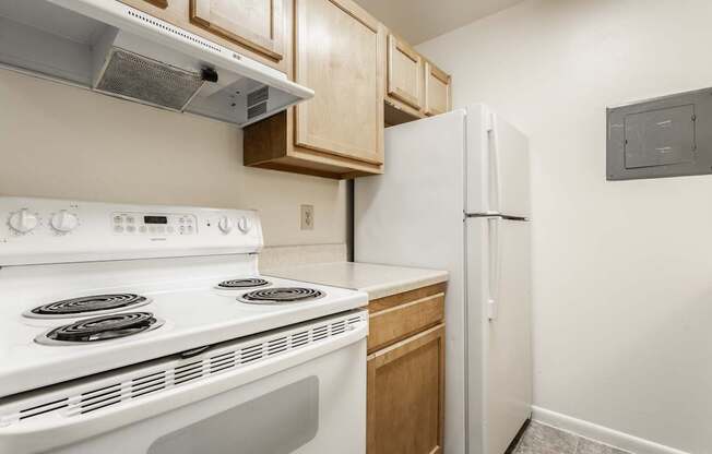 a kitchen with white appliances and a refrigerator