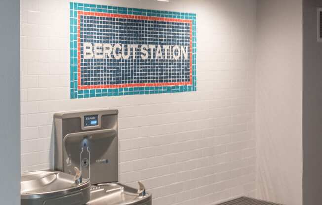 a public restroom with a urinal and a sink and a bench