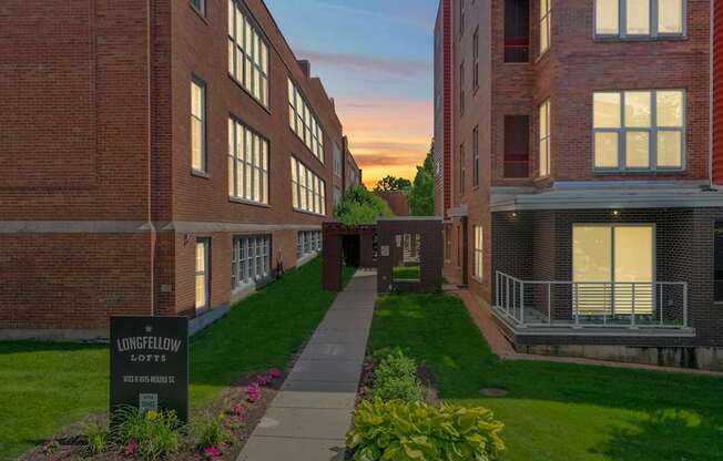 A building with a sign that says "LONGFELLOW LOFTS" in front of it.