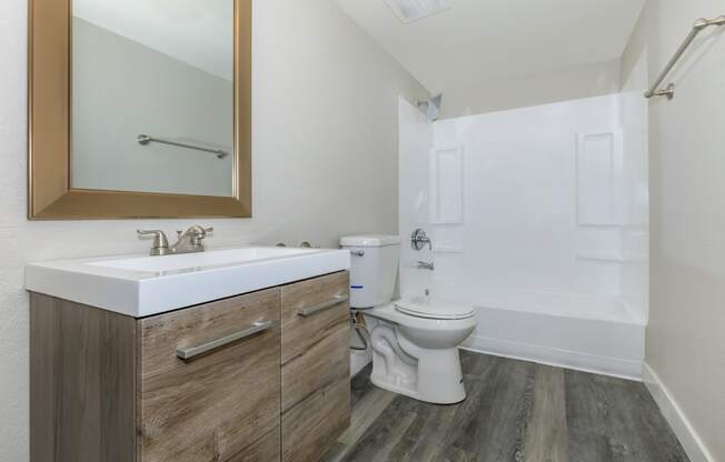 a bathroom with a toilet sink and bathtub