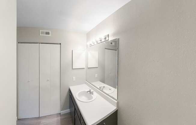 an empty bathroom with a sink and a mirror