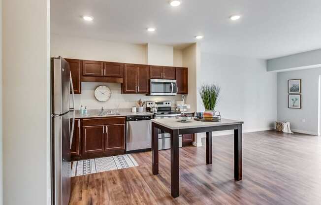 a kitchen with dark wood cabinets and stainless steel appliances