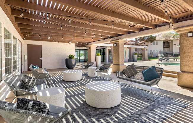 a patio with couches and tables and chairs