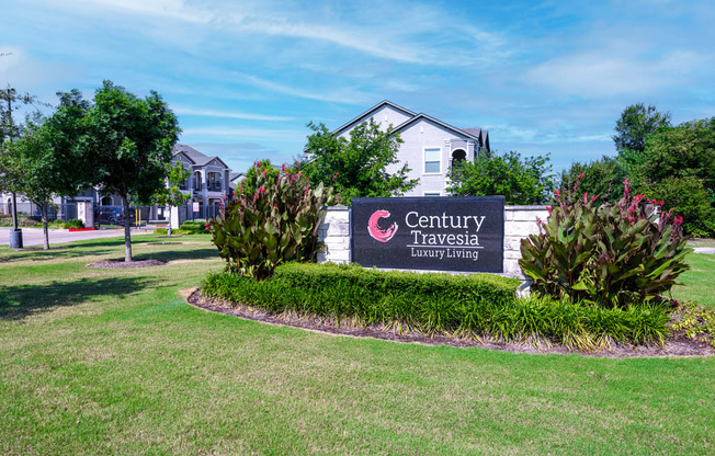 Property sign surrounded by bushes and greenery