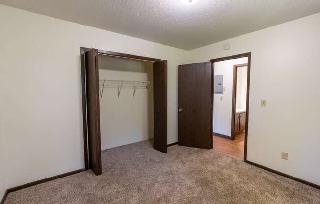 Bedroom with two closets and a carpeted floor at Parkwest Gardens West Fargo