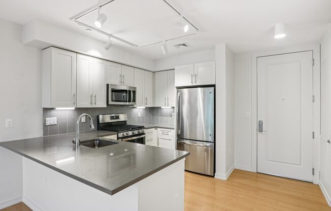 Kitchen with stainless steel refrigerator, microwave, and oven at Park77 Apartments, Massachusetts, 02138