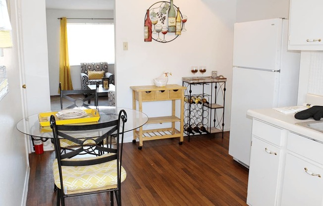 a small kitchen and dining room with a table and chairs