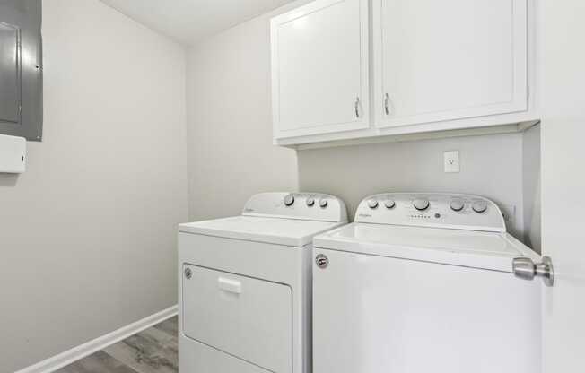 A white washer and dryer in a laundry room.