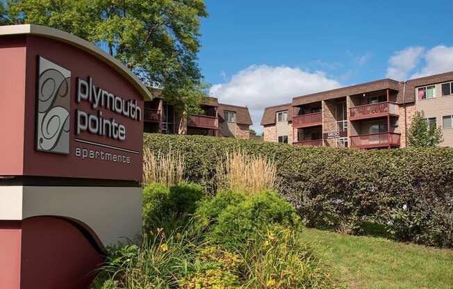 Plymouth Pointe monument sign surrounded by lush greenery