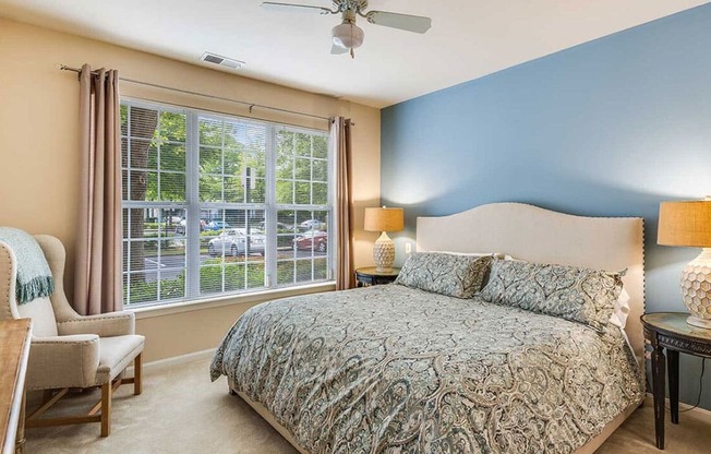 a bedroom with a bed and a ceiling fan