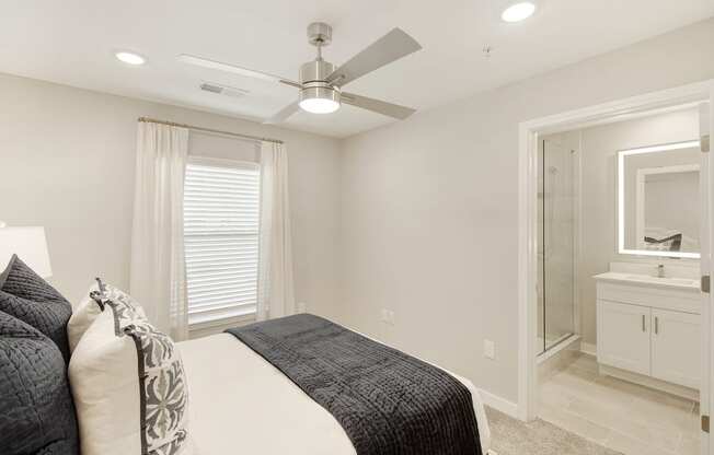 a white bedroom with a large bed and a ceiling fan at The Azul in Oxford, MS
