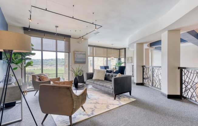 a living room with couches and chairs and a balcony