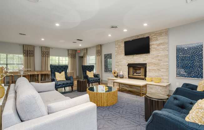 a living room with couches and chairs and a fireplace