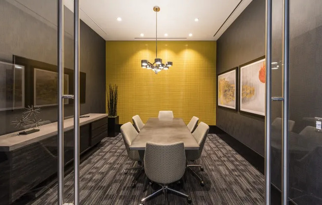 Conference room at our apartments in Arlington, featuring carpeted flooring and a conference table with chairs.
