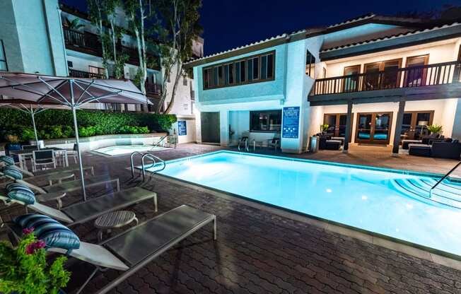 Nighttime pool with lounge seating