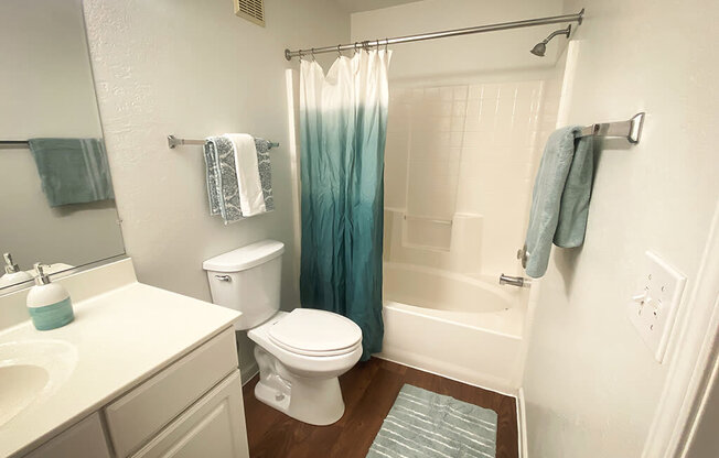 A white toilet sits next to a sink in a bathroom.