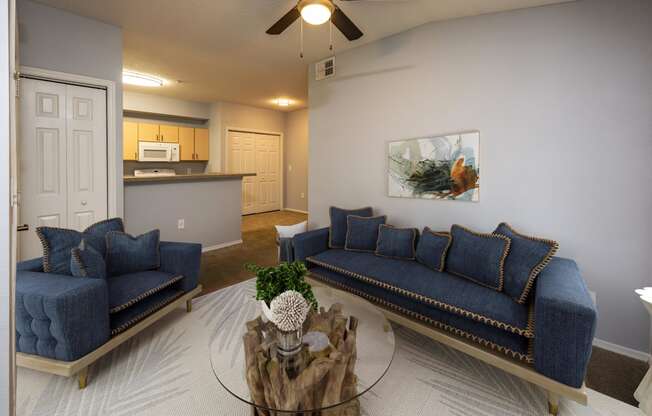 a living room with blue couches and a coffee table