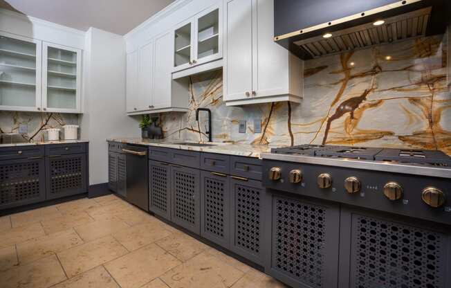 a kitchen with a large island and a stove and cabinets