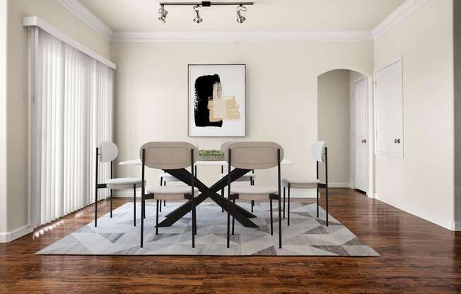 A dining room with a table and chairs.