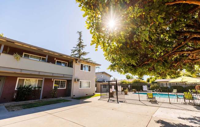 A sunny day at the apartment complex with a pool in the background.