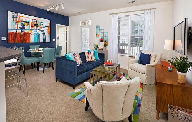 a living room with blue walls and white furniture