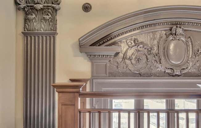 A balcony with a railing and a column with a decorative capital. at The Knights @ 506 Delaware Apartments, Buffalo, New York