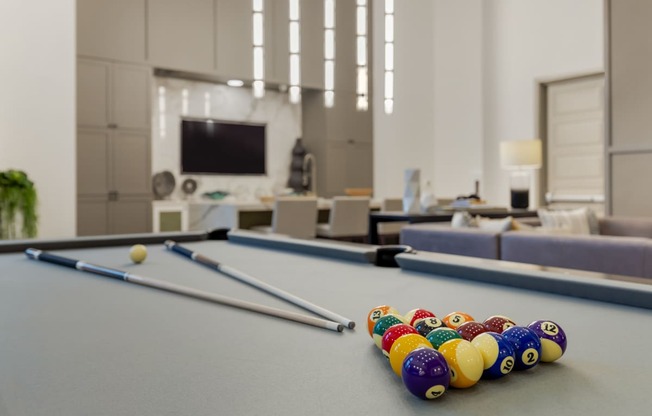 a games room with a pool table and a television