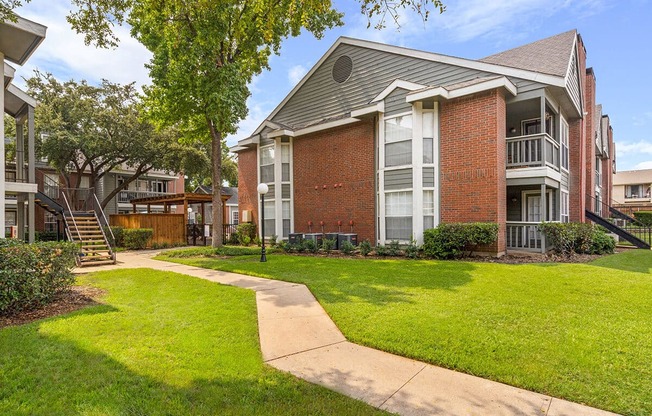 our apartments offer a spacious courtyard with green grass and trees