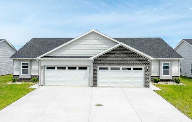 A two-car garage is attached to a house.