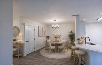 A dining area with a round table and chairs.