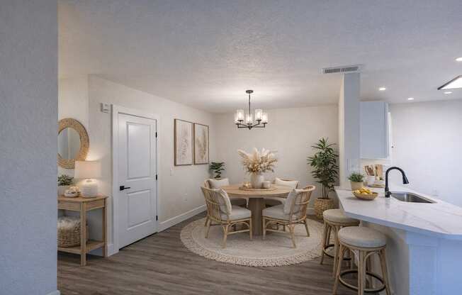A dining area with a round table and chairs.