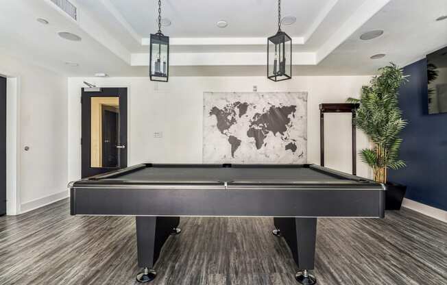 a game room with a pool table and a tv